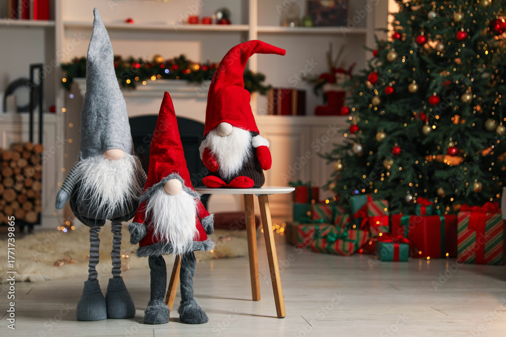 Obraz premium Funny Christmas gnomes in festive decorated room, space for text