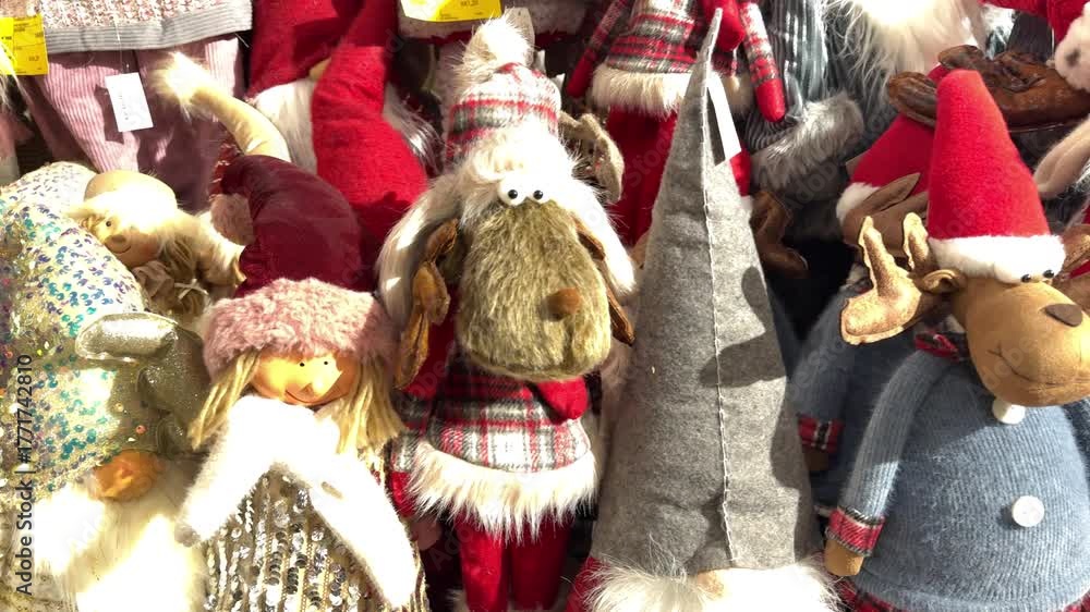 Colorful selection of handmade christmas gnome dolls, reindeer, and other festive stuffed toys displayed for sale at a holiday market, creating a cheerful and celebratory atmosphere