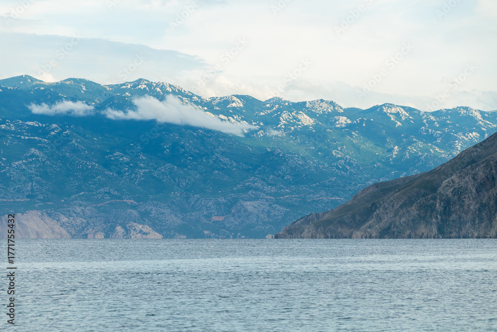 Obraz premium Tranquil coastal view of mountain range and calm blue sea