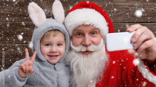 Smiling santa and child in bunny costume taking selfie in snowy scene