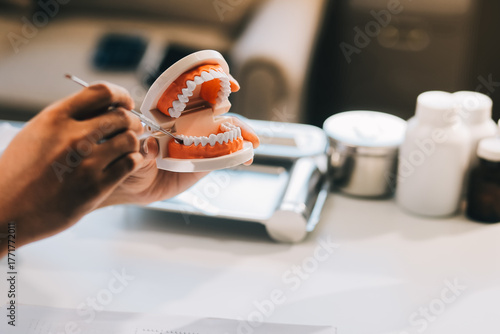 Fotografía A dentist is using specialized dental equipment to inspect dentures to study the anatomy of the teeth before using the knowledge to treat patients, Dentures are being studied by oral specialists