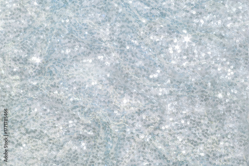 The background of the fabric is decorated with a scattering of silver sequins creating an abstract shimmer.