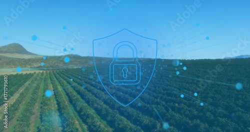 Displaying padlock in shield outline overlay over orchard rows, with glowing nodes, radiating lines