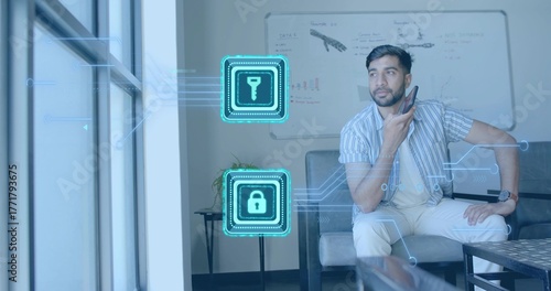 Wallpaper Mural Talking man holding smartphone to mouth on sofa at office, key and lock icons, copy space Torontodigital.ca