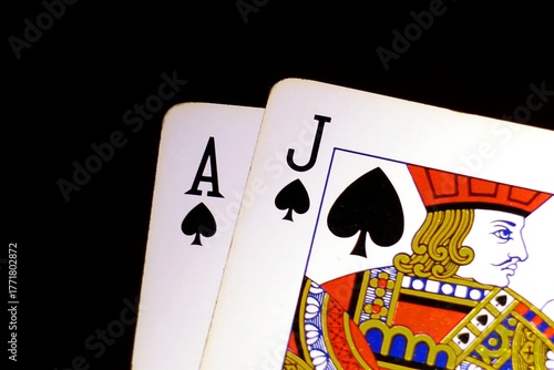 Blackjack bonus concept: Close-up of isolated blackjack cards on a black background, Jack of Spades and Ace of Spades