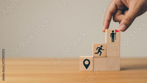 Minimalist business success concept showing teamwork, goal achievement, and leadership represented by wooden blocks and symbolic icons.