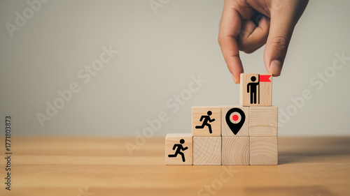 Minimalist business success concept showing teamwork, goal achievement, and leadership represented by wooden blocks and symbolic icons.