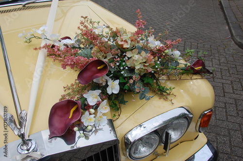 Elegant Vintage Cream Wedding Car With Floral Arrangement Of Hydrangea Orchids And Ivy
