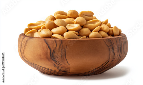 A close-up, eye-level studio shot of a rustic wooden bowl filled with shelled, roasted peanuts (groundnuts), isolated on a white background.