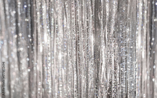 Metallic silver curtain glitter background surface in a bright setting
