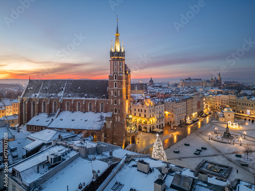 St Mary's church and Christmas tree on the snow covered Main Square in the winter dawn, Krakow, Poland