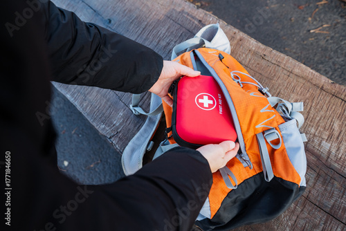 Preparing medical gear outdoors, Organizing safety supplies for family outdoor exploration, Ensuring all necessary health and safety items are packed for family outings in nature