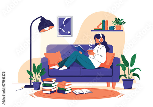 Woman unwinding at home on a comfortable couch, reading a book, wearing headphones, and enjoying a hot drink.