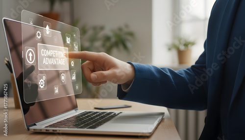 businessman selecting digital competitive advantage icons on laptop screen
