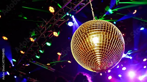 Dazzling disco night with golden mirror ball sparkling colorful stage lights, vibrant party atmosphere, energetic celebration, nightlife event