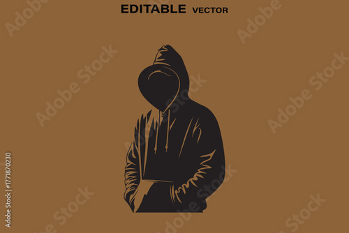 Mysterious person in a dark hoodie with face obscured by shadow