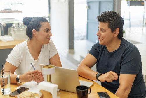 Hispanic couple working together at a bakery