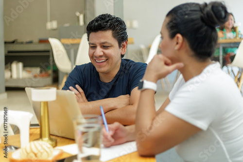 Smiling Man and Woman Collaborating in a Bakery