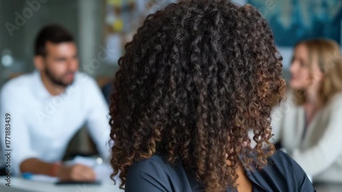 Confident businesswoman smiling during a meeting in a modern office environment