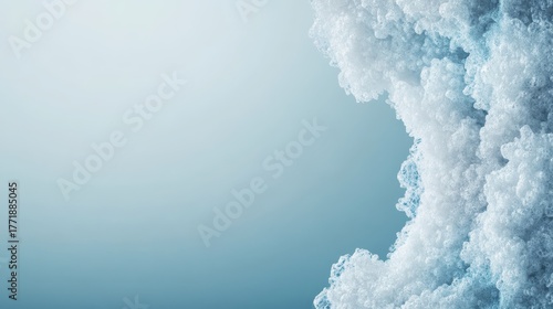 Microscopic view of crystalline cellular structures forming in a pale blue laboratory fluid, abstract biological background.