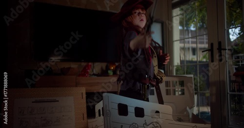 Little Boy Dressed as Pirate Giving Orders on a Cardboard Ship