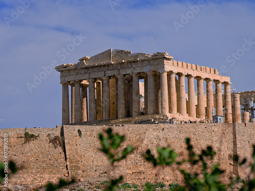 Close-up of  Parthenon, the colossal Doric temple dedicated to Athena, atop the Acropolis of Athens. The ancient stone stands against a dramatic sky, symbolizing the grandeur of Classical Greece.