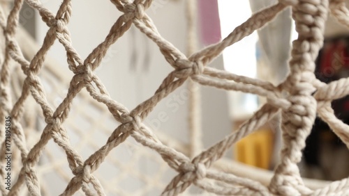 Bild auf Leinwand Close-up shot of a rope net, blurred background