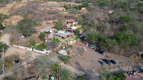 Aerial reverse motion from rustic hacienda in El Chilar, unveiling part of the rural town and terrain