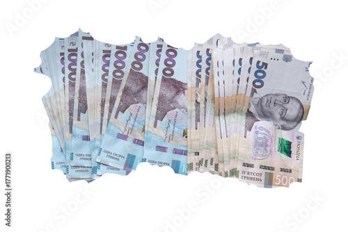 Stack of torn Ukrainian hryvnia banknotes, including 1000 and 500 bills, isolated on transparent background as a symbol of inflation.