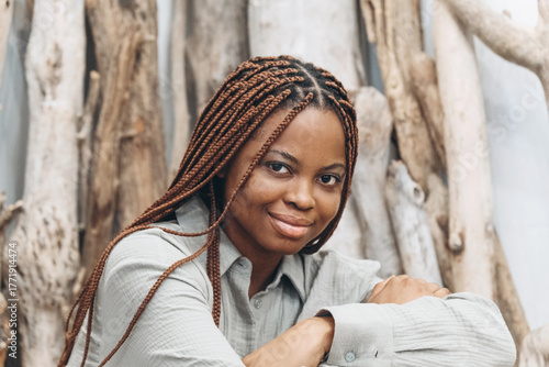 Portrait of a woman with beautifully braided hair on the background of a natural landscape