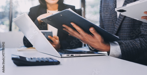 Accounting company provide finance and taxation planning for profitable cash flow, Auditor and accountant team working in office, analyze financial data and accounting record with calculator.Insight