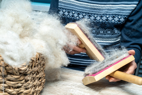 The skill of carding wool by hand, is crucial for producing quality yarn.