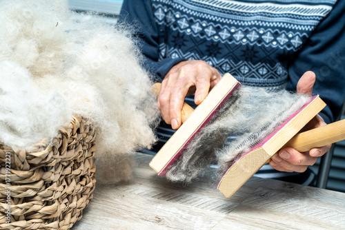 The skill of carding wool by hand, is crucial for producing quality yarn.