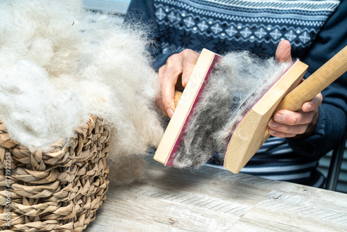 The skill of carding wool by hand, is crucial for producing quality yarn.