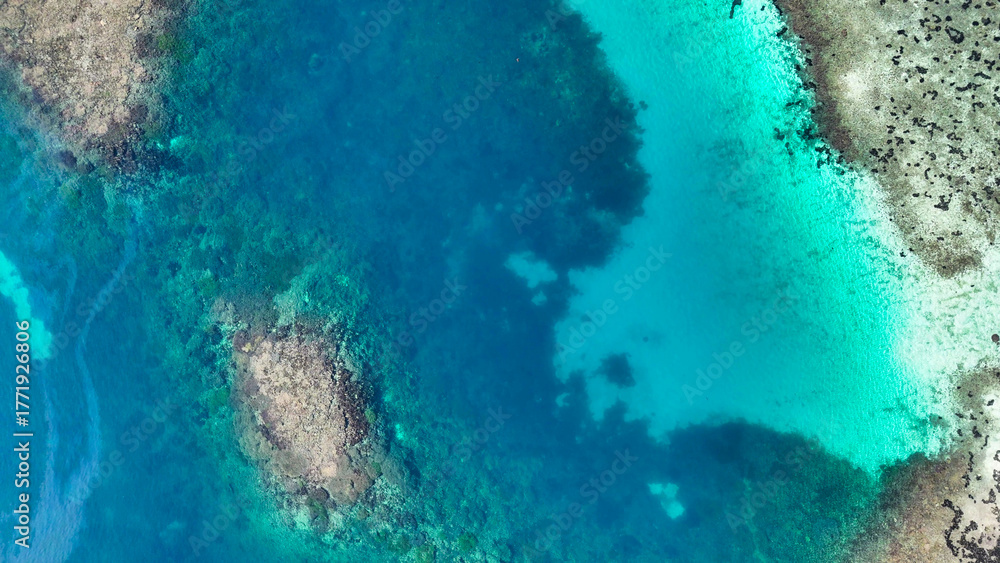 Obraz premium Aerial view of Pulau Karangan in Komodo National Park showing vibrant coral reefs and turquoise waters