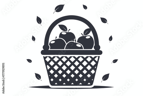 Wicker basket filled with harvested apples surrounded by falling leaves creates a simple scene