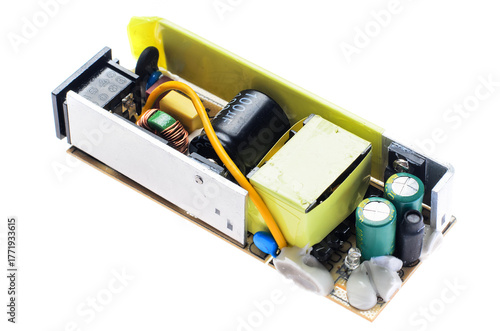 Damaged power supply board with swollen capacitor on white background