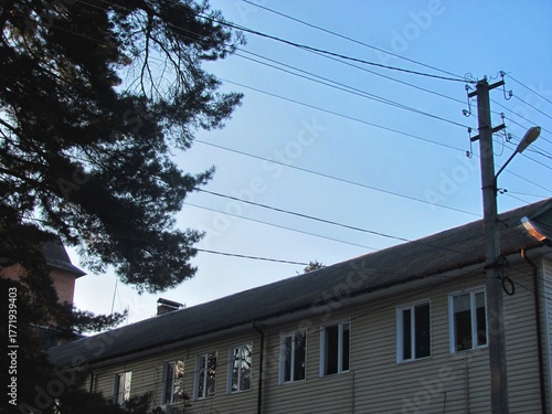 Old building with corrugated slate roof at dusk