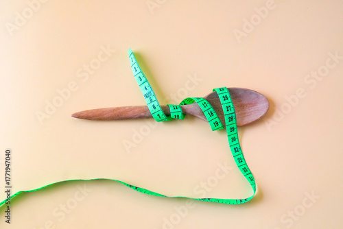 A Measuring tape for tying wood spoon,diet, healthy lifestyle concept.