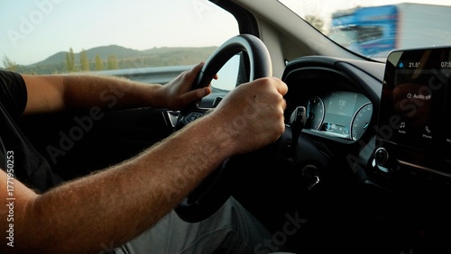 Close-Up of Man Driving Car with Hands on Steering Wheel