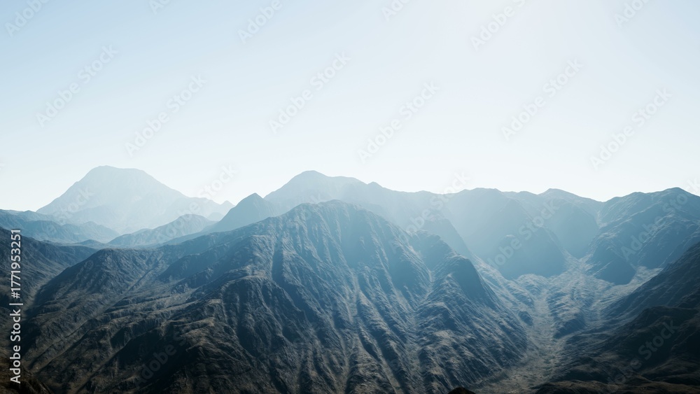 Fototapeta premium Breathtaking mountain ranges stretch across the horizon, bathed in soft morning light. The rugged terrain showcases the raw beauty of nature, inviting exploration and admiration.