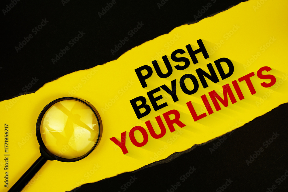 Naklejka premium Push Beyond Your Limits text on yellow with black paper torn ripped and magnifying glass