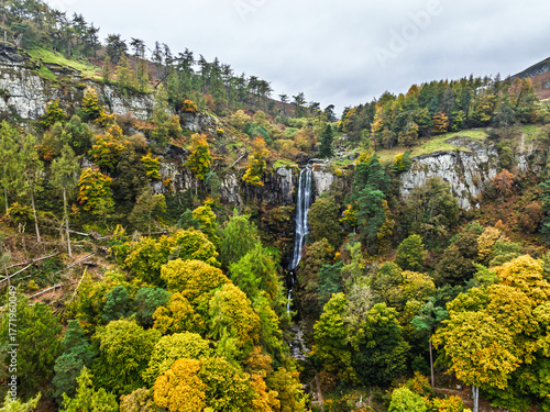 Autumn colours over Pistyll Rhaeadr Waterfall and Berwyn Mountains from a drone, Oswestry, Shrewsbury, Wales, England