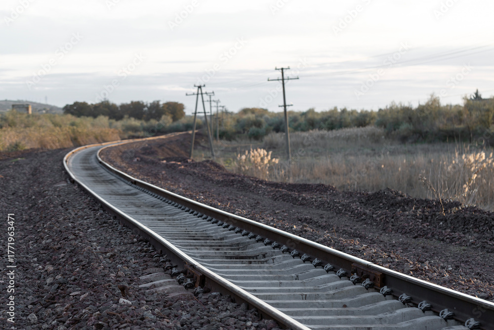 Obraz premium Railway tracks at sunset. New infrastructure for train traffic