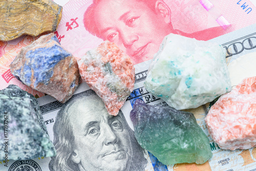 Macro view of raw mineral ore on US $ and Chinese ¥ banknotes, illustrating critical-minerals dependency, trade shifts and investment opportunities in raw-materials.