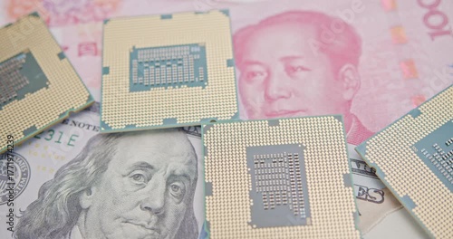 Close-up of semiconductor CPU chips on U.S. dollar and Chinese yuan banknotes. Represents global electronics supply chain, U.S.–China tech tensions and investment in chips.