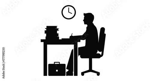 A focused professional working late at a desk striking silhouette