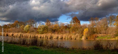 Autumn colors of a provincial region. A local pond and recreation area. A charming autumn landscape.