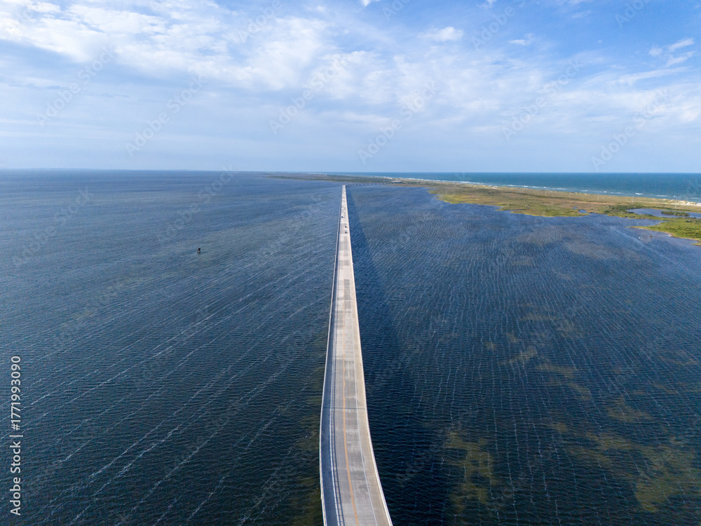 custom made wallpaper toronto digitalAn aerial view shows Rodanthe Bridge commonly called the Jug Handle Bridge crossing a wide ocean, carries North Carolina Highway 12 from Rodanthe to the southern point of Pea Island