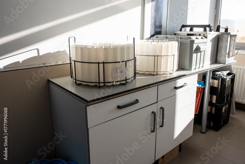 Obraz na plátně Blue plastic storage boxes on a laboratory counter